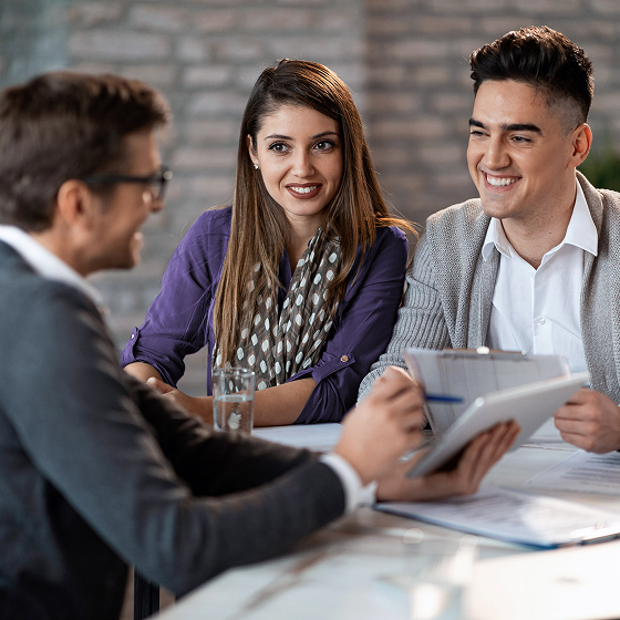 Financial professional engages customers in a discussion about life insurance strategies.