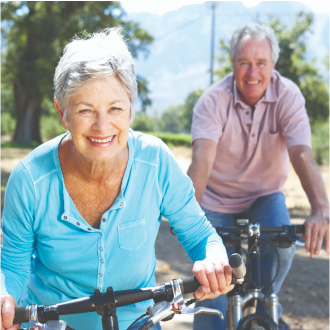 Retired couple enjoying a bike ride after securing their income 