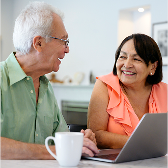 A couple discussing their reliable income stream from an immediate annuity.