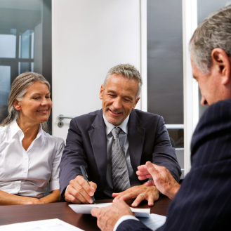 Financial professional helping clients understand risks to retirement. 