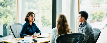 Financial professional having a conversation with her clients about life insurance and retirement