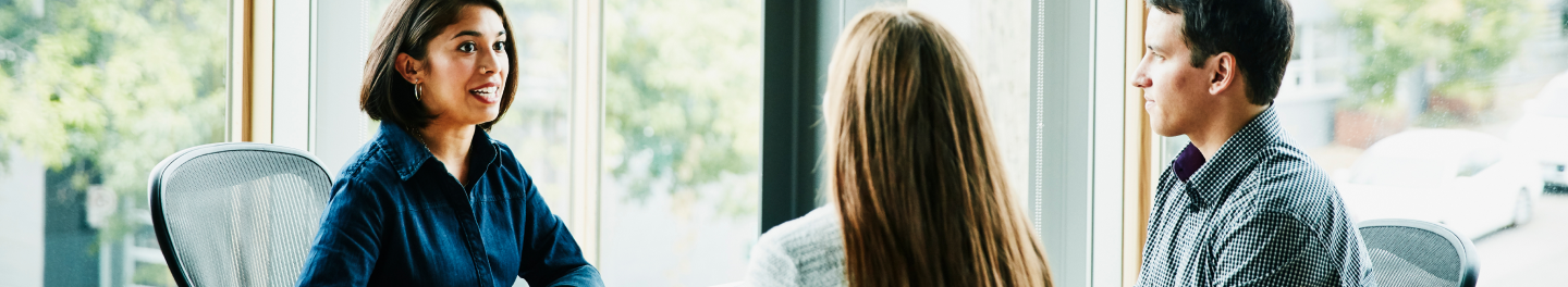 Financial professional having a conversation with her clients about life insurance and retirement