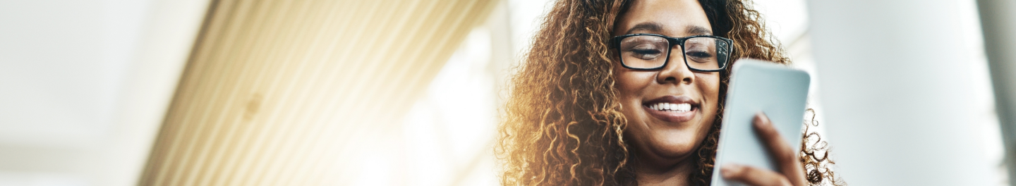 A financial professional using her phone to do business with Protective