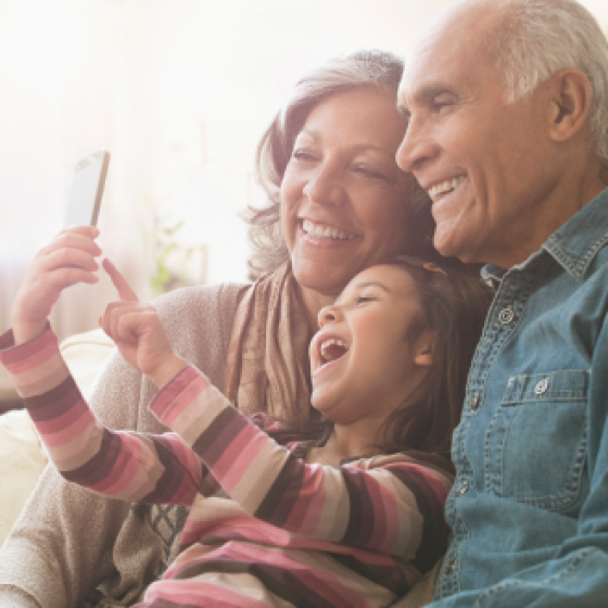 Grandparents smile with their grandson as they think about the financial legacy they've created with Protective Series Estate Maximizerw