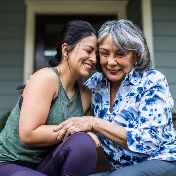 A mother and daughter hugging.