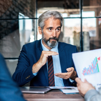 Financial professional discussing market challenges with client. 