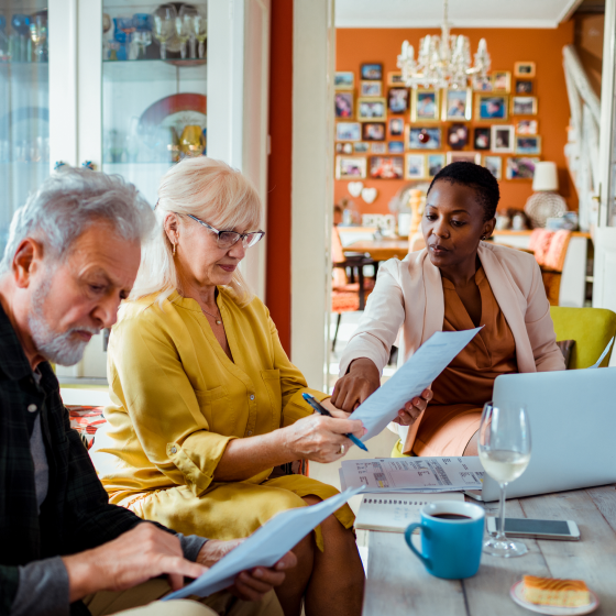 financial advisor explaining to a couple how tax strategies can help optimize retirement planning