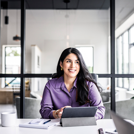 Woman evaluates life insurance needs not met by her employee benefit plan on her mobile tablet.