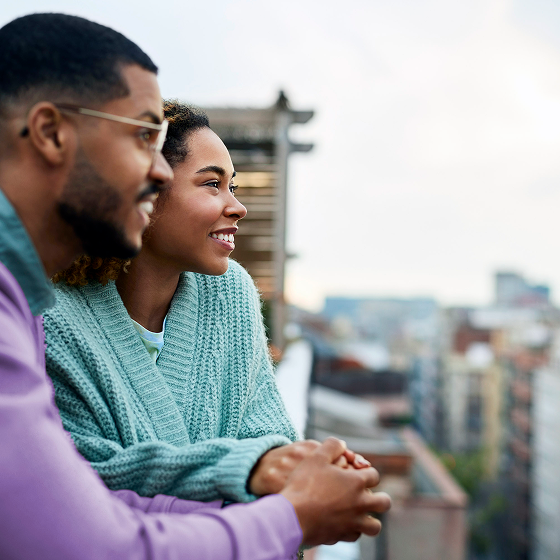 Young couple enjoys a rooftop view, representing people who think only families with children need life insurance.