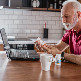A man using his computer to review income risks to consider when retirement planning
