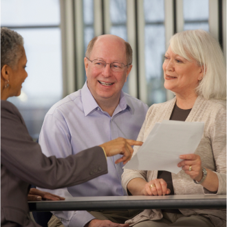 A financial professional discussing potential risks of accumulating retirement savings with her clients.