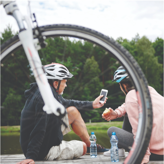 A couple enjoying a bike ride confident that they have planned for Social Security in retirement.