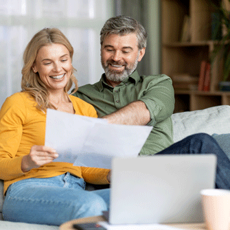 Happy couple reviewing financial documents
