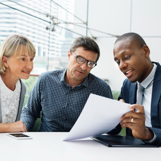 A financial professional explaining the features of Protective Series Whole Life to a husband and wife