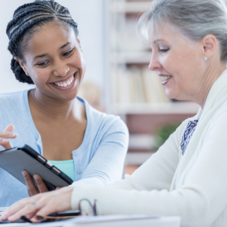 A financial professional showing a retired woman the benefits of Protective Series Whole Life Simplified Issue insurance