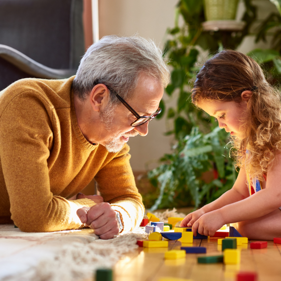 Man, who represents potential Protective Indexed Annuity NY client, plays with his granddaughter.