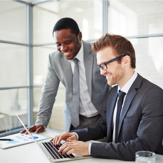 A Branch manager helps an agent locate the life leads report on a laptop.