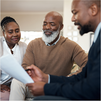 A financial professional meeting with a couple to discuss changes to their life insurance needs.