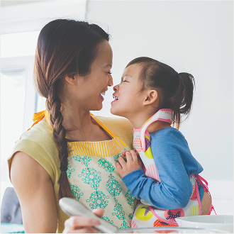 A mother holding her young daughter, knowing her family is protected with Protective Classic Choice term.