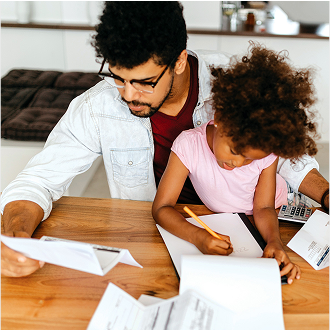 A father reviewing financial documents while sitting with his young daughter.