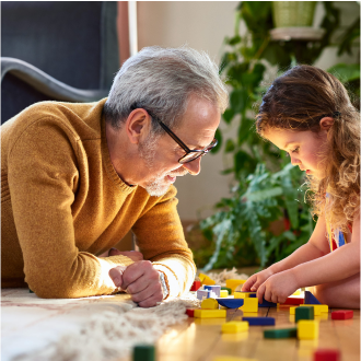 Man, who represents potential Protective Indexed Annuity NY client, plays with his granddaughter.