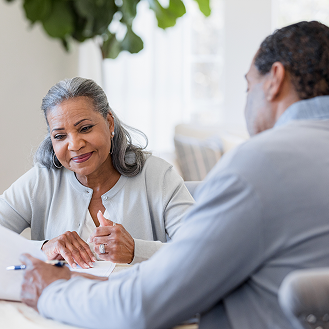 A woman reviewing Protective Smart Saver NY with her financial professional.