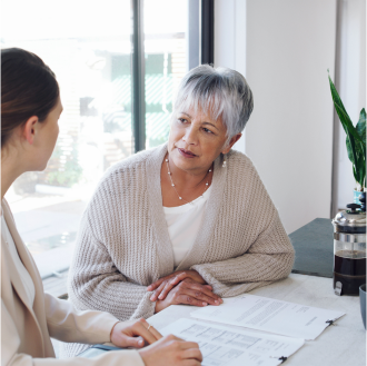 A financial professional meeting with a woman about retirement strategy.